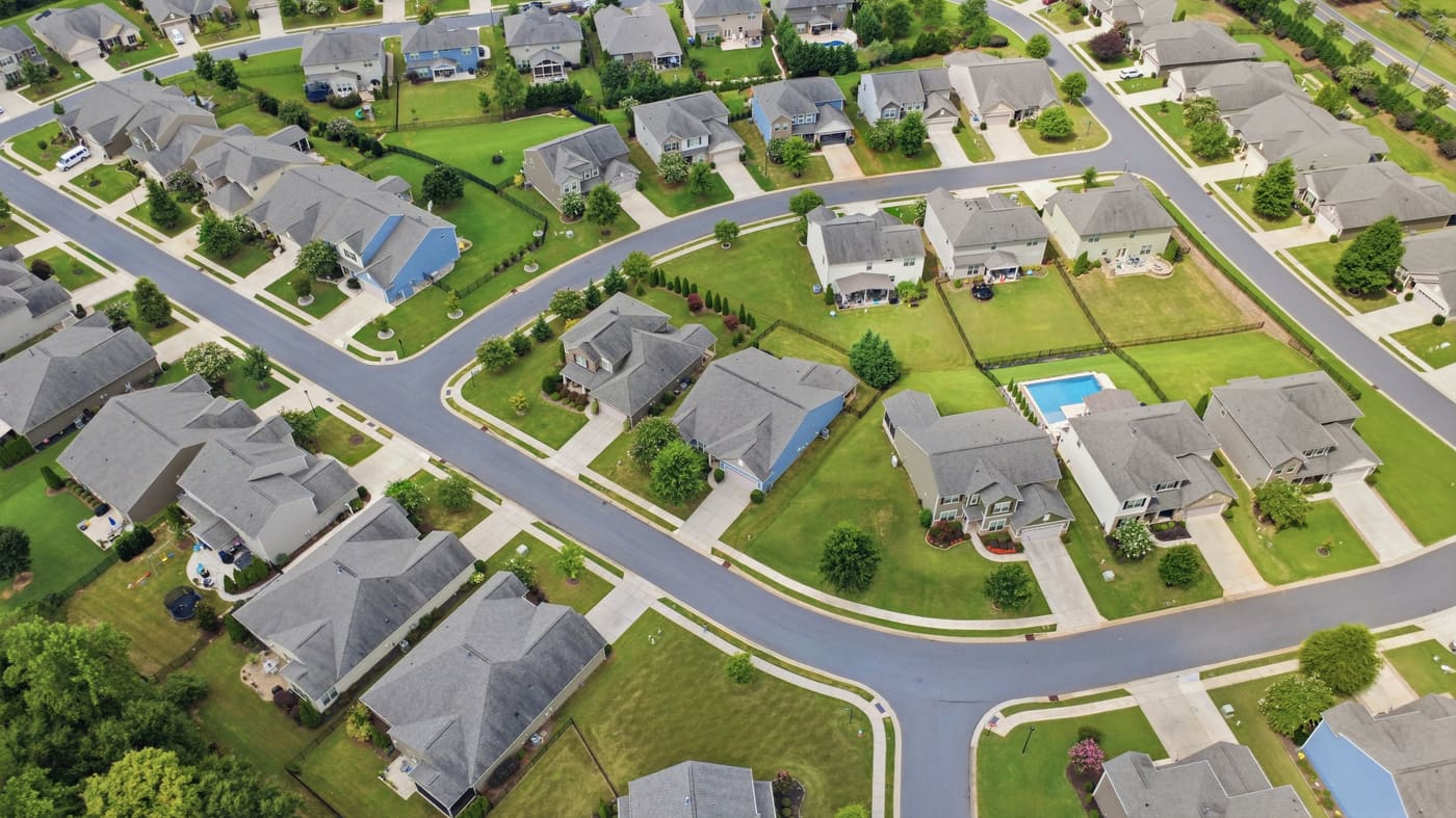 Queensbridge from the air, showing curving streets, mature lawns and a neighborhood pool.