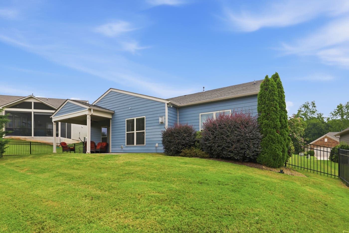 The rear yard in full, with the tree line behind.
