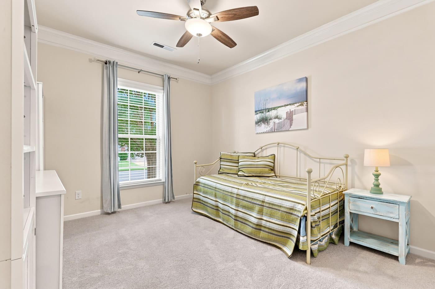 The third bedroom, carpeted, with a window to the side yard.