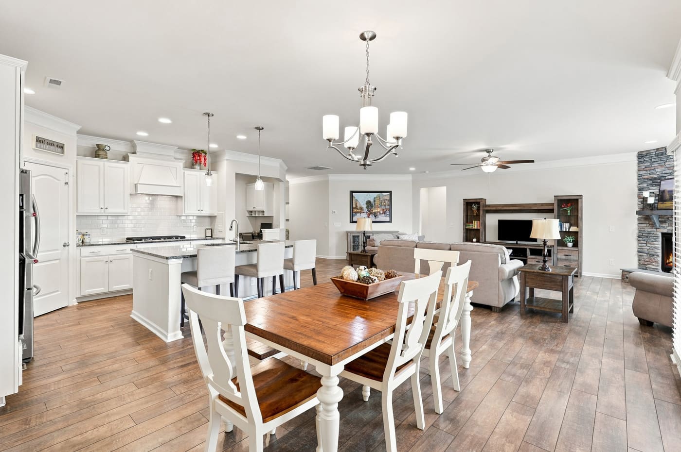 The dining table with the kitchen and family room beyond.